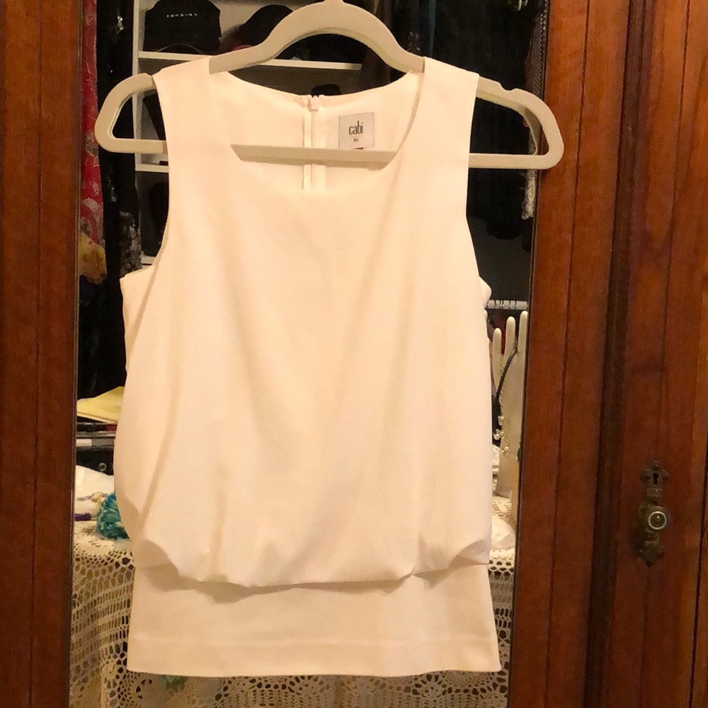 Cabi sleeveless top with blouson design above a rayon, nylon spandex knit XS